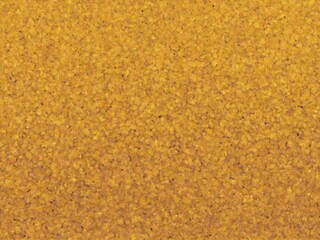 Seamless golden texture with a speckled, granular appearance, perfect for backgrounds, website designs, and various creative projects.