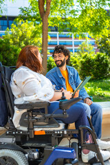 University students talking and smiling in campus park, mobility aid user and friend having...