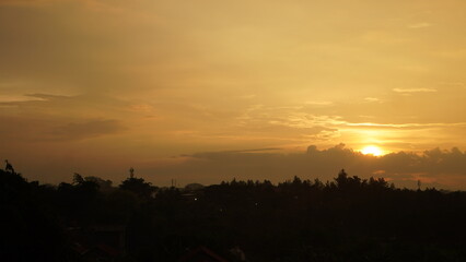 Golden Sunset Silhouette Over Silhouetted Treescape