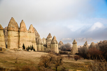 Unique fairy chimneys in Cappadocia landscape under a cloudy sky