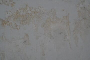 Weathered Concrete Wall with Cracks and Patches of Discoloration, Textured Surface