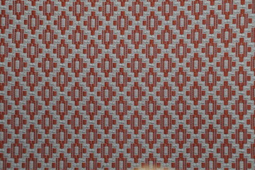 Detailed Close-Up of Woven Fabric with Geometric Red and Gray Pattern