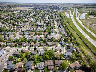 Suburban neighborhood with houses and a highway in the background