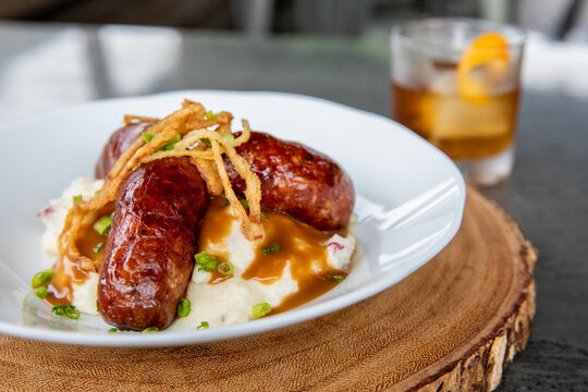 Bangers and Mash-Irish sausage on top of a mount of mashed potatoes 