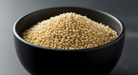 Pile Of Uncooked Quinoa In A Black Bowl On A Dark Background