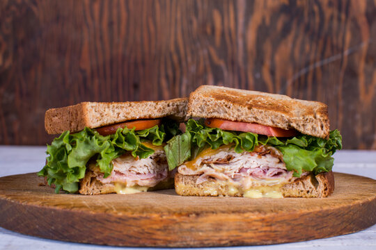 Turkey deli sandwich on toasted wheat bread with potato salad and iced tea 