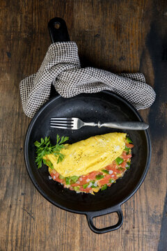 Vegetable and cheese omelet with coffee, toast and fruit 