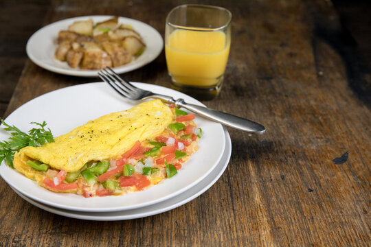 Vegetable and cheese omelet with coffee, toast and fruit 