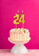 Number 24 birthday candle - Pink celebration cake with drip icing