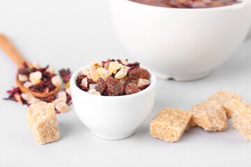 Bowl with dried fruit tea and snacks isolated on white background