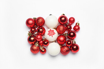 Christmas balls with drawn maple leaf on white background. Canadian flag concept