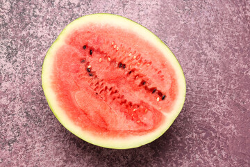 Half of fresh watermelon on purple background