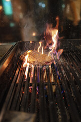 beef steak sizzling on an open flame grill