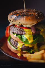 delicious beef burger with fresh vegetables, and sesame bun, served with golden fries, ideal for food and restaurant visuals