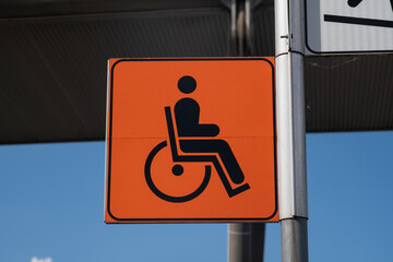 Slope road warning sign, signage indicates accessibility with sloping asphalt sidewalk, useful for wheelchair access as indicated by the highway code, now common in urban areas of the city. news.