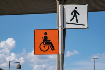 Slope road warning sign, signage indicates accessibility with sloping asphalt sidewalk, useful for wheelchair access as indicated by the highway code, now common in urban areas of the city. news.