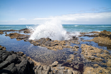 Waves Crashing on Rocky Shore Near the Ocean