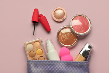 New cosmetic bag with makeup products on purple background