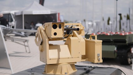 An unmanned ground vehicle outfitted with a precision weapon system is showcased at a defense...