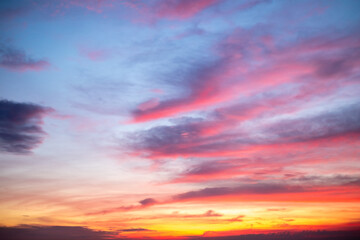 Fototapeta premium Sky,Beautiful sunset view, luxury soft gradient orange gold clouds and sunlight on the blue dramatic sky perfect for the background, morning, evening,Twilight, climate change,horizontal sunset photo