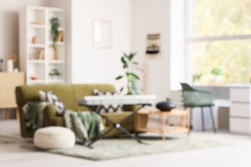 Fototapeta premium Blurred view of living room with sofa, glucophone and synthesizer
