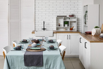Dining table with beautiful setting in kitchen
