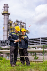 Engineers male, female working with tablet in industry oil refinery oil, gas refinery background, Business petrochemical industrial  Ecosystem estates. Fuel refinery industry for transportation.