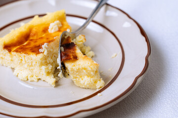 Creamy slice of cheesecake being enjoyed on a plate