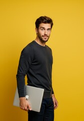 Portrait Handsome Man Holds Laptop Computer on Yellow Background