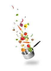 Fresh vegetables and saucepan in air against white background