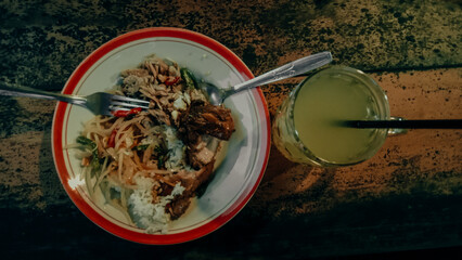 dinner with stir-fried and grilled chicken, accompanied by warm orange juice