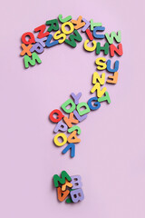 Question mark made of colorful English letters on lilac background