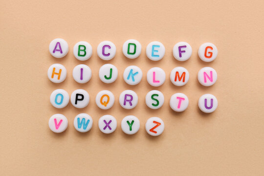 English letters on beige background