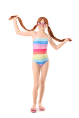 Little redhead girl in swimsuit on white background
