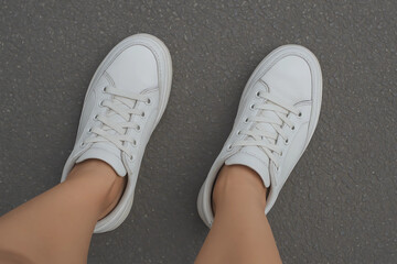 female feet in white shoes