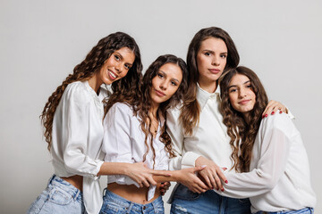 Smiling Group of Friends Posing in Fashionable White Shirts and Jeans