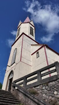 White Historic Church Tower Against Bright Blue Sky San Agustin Parish Puerto Octay