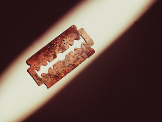 Close-up image of a rusty, old and unused razor blade