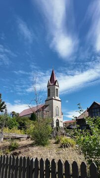 White Historic Church Tower Against Bright Blue Sky San Agustin Parish Puerto Octay