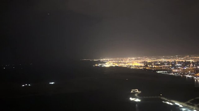 View from a plane flying over Dubai at night. 