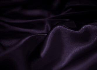 Luxury silk satin fabric background. Fashion elegant dark shade of purple and black. Waves and...