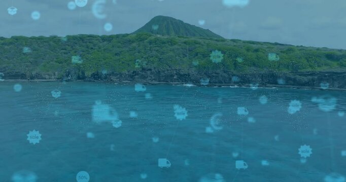 Fading turquoise icons animating over tropical volcanic island, drifting to represent commerce
