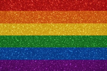 Vibrant sparkling rainbow glitter background in pride flag colors