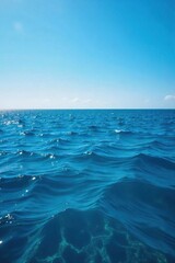 Vast expanse of deep blue ocean water, sunlit surface with gentle waves creating ripples and textures Perfect for travel, nature, and environmental themes , sky, marine