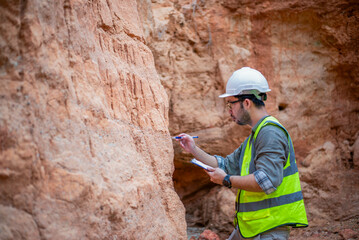 A geologist is examining the soil layers in a valley.