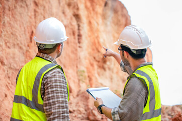 Expert geologists are analyzing layers of rocks that have been deposited for a long time to learn about past organisms and plants.