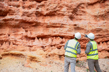 Expert geologists are analyzing layers of rocks that have been deposited for a long time to learn about past organisms and plants.