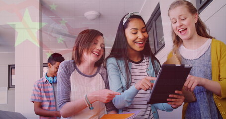 Image of flag of china over happy diverse girls using tablet at school