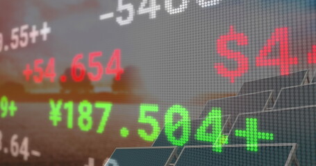 Image of financial data and graphs over solar panels