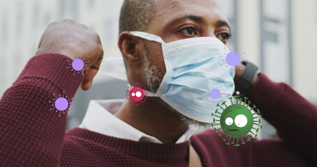 Image of flag of canada waving over woman in face masks